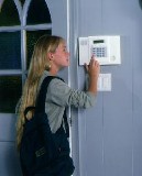 Girl setting Alarm - Security Systems in Cranston, RI